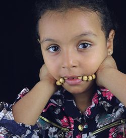 Close-up portrait of girl with beaded necklace