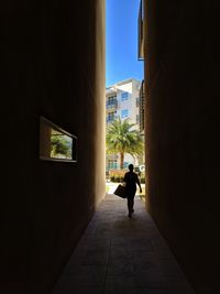 Rear view of woman walking in corridor