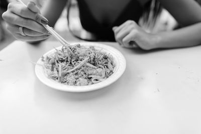 Midsection of woman holding ice cream in bowl