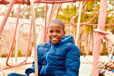 Portrait of happy boy playing in park