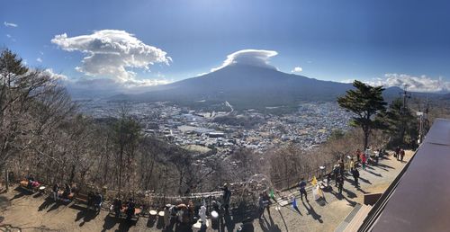 Panoramic view of crowd on mountain against sky