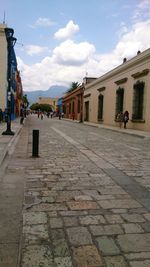 View of footpath against cloudy sky