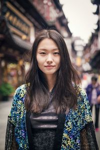 Portrait of smiling young woman in city