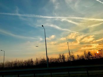 Silhouette trees against sky at sunset