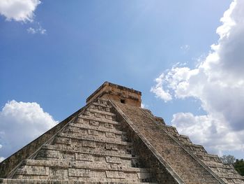 Low angle view of old building against cloudy sky