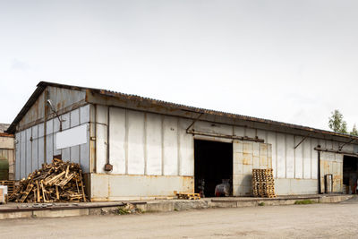 Exterior of abandoned building against clear sky