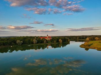 Scenic view of lake by building against sky