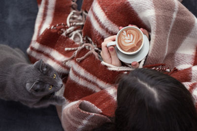 High angle view of cat drinking coffee