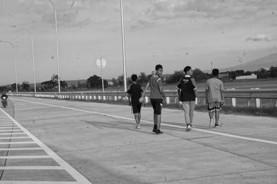 People playing basketball court against sky