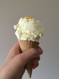 Close-up of hand holding ice cream cone