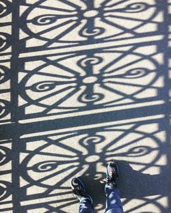 Low section of person standing on metal