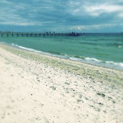 Scenic view of sea against cloudy sky