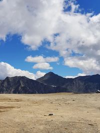 Scenic view of landscape and mountains against sky