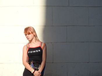 Woman standing against wall