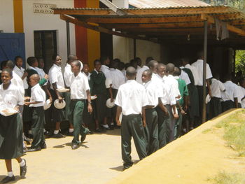 Group of people standing on tiled floor