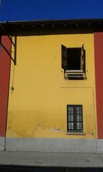 Low angle view of building against blue sky