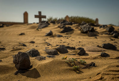 Surface level of sand on beach cemetery against sky, cofete, fuerteventura 