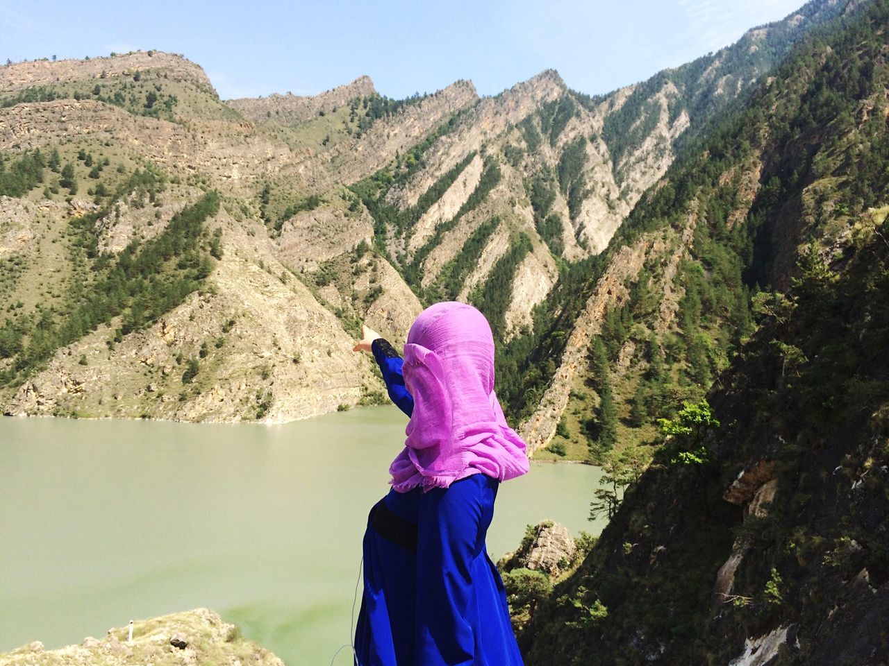 mountain, mountain range, rear view, lifestyles, tranquil scene, leisure activity, beauty in nature, scenics, tranquility, standing, casual clothing, nature, water, person, lake, rock - object, rock formation, tourist