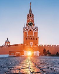 View of clock tower in city against sky at sunset