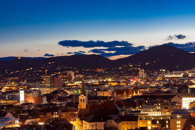 High angle view of illuminated buildings in city at night