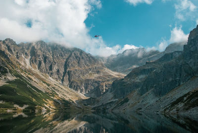 Scenic view of mountains against cloudy sky