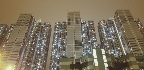 Low angle view of illuminated cityscape at night