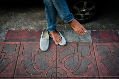 Low section of man standing on street