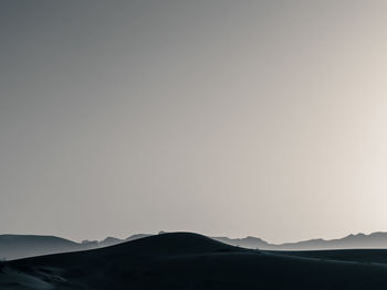 Scenic view of silhouette mountains against clear sky