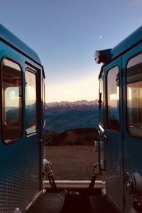 Train on railroad track against clear blue sky during sunset