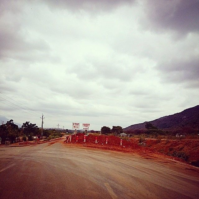 sky, cloud - sky, road, cloudy, mountain, building exterior, architecture, built structure, landscape, cloud, the way forward, overcast, weather, transportation, nature, scenics, tranquility, tranquil scene, mountain range, street