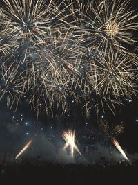 Low angle view of firework display at night
