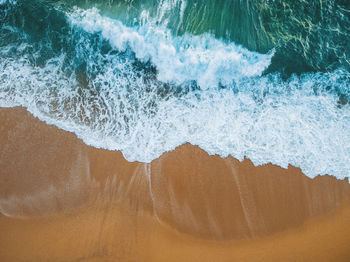 High angle view of waves on beach