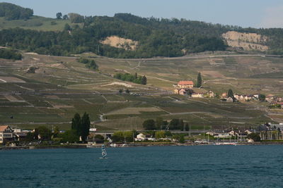 Scenic view of landscape and buildings against sky