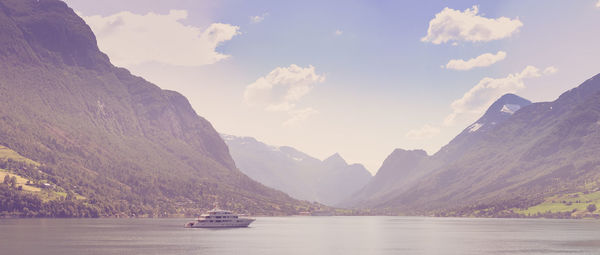 Scenic view of sea and mountains against sky