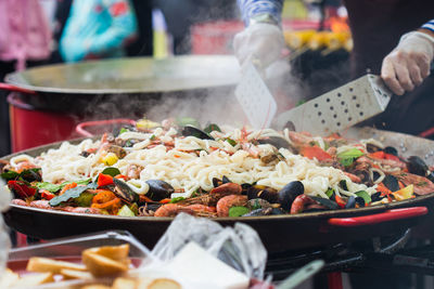 Person preparing food at market stall