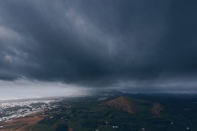 Scenic view of mountain against cloudy sky