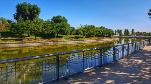 Scenic view of lake against clear blue sky