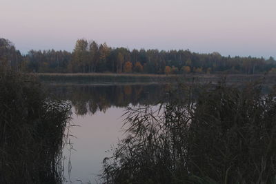 Scenic view of lake against sky at sunset