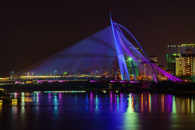 Illuminated bridge at night