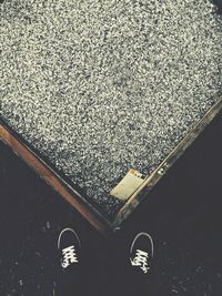 Low section of person standing on tiled floor