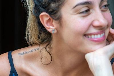 Close-up portrait of a smiling young woman