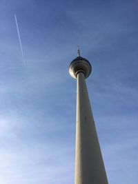 Low angle view of communications tower against blue sky