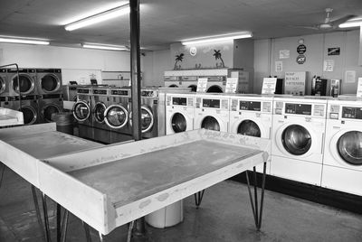 Tables by washing machines in laundry