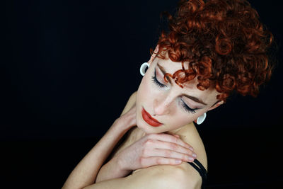 Close-up of woman hand against black background