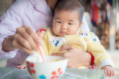 Portrait of cute baby girl holding ice cream