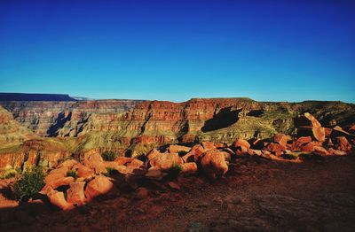 Scenic view of rocky landscape against clear blue sky