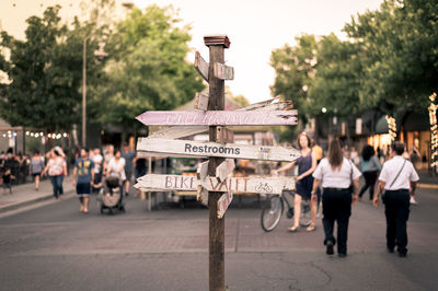 People by information signs on street