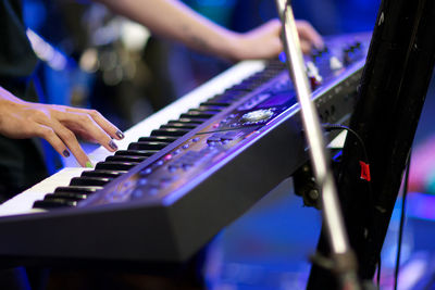 Midsection of woman playing piano