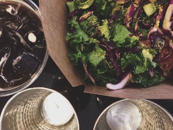 Directly above view of salad and containers on table