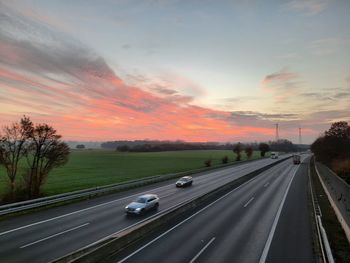 Highway against sky during sunset